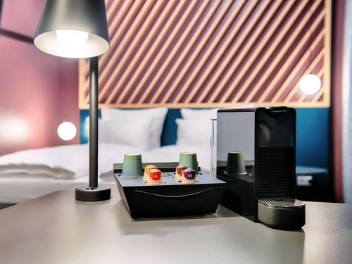 a desk with a lamp and a computer on it at B&B Hotel Willingen in Willingen