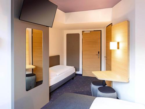 a hotel room with a bed and a desk at B&B Hotel Willingen in Willingen