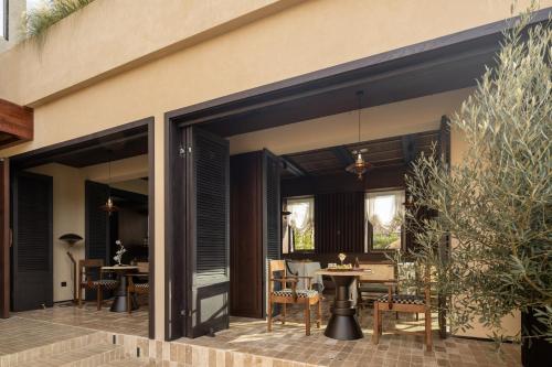 an open patio with a table and chairs at 大理空山语 风眠艺术海景酒店 Dali Kongshanyu Art Seaview Hotel in Dali Airport