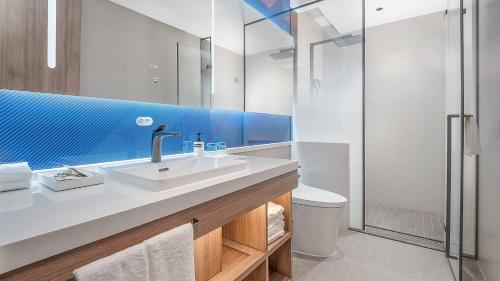 a bathroom with a sink and a shower at Holiday Inn Express Foshan Shunde Lecong by IHG in Shunde