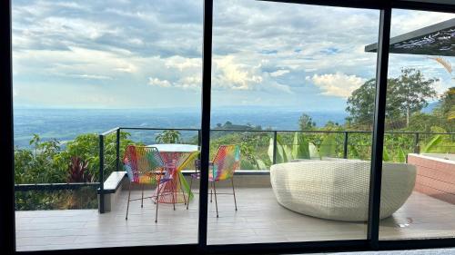 a balcony with a table and chairs and a view at La Font Ecolodge in Buenavista