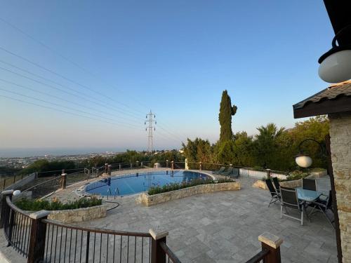 a patio with a swimming pool and a fence at Villa Melandra in Engomi