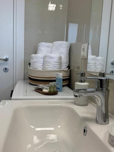 a bathroom with a sink and a mirror and towels at Gate 12 in Otopeni