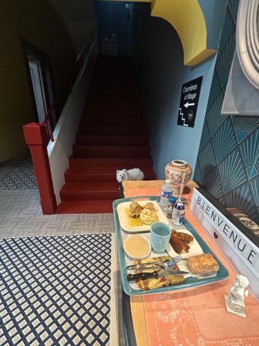 a table with a tray of food on top of it at Hôtel Déco'lia-Soirée étape in Ballon