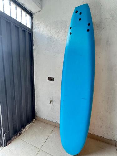 a blue surfboard leaning against a wall next to a door at "Seaside Studio with Stunning Views in Belyounech in Belyounech 