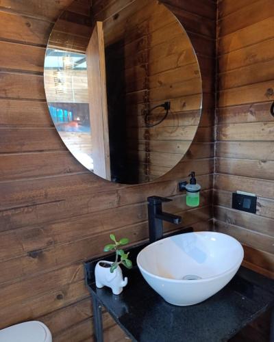 a bathroom with a white sink and a mirror at Gampling el Cielo los pinos in Rionegro