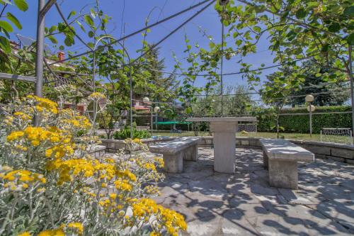 a garden with benches and flowers in a park at Lucia in Gračišće - Istrien in Gračišće