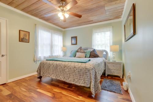 a bedroom with a bed and a ceiling fan at 4 Mi to Jetty Park Beach! Family Home with Game Room in Fort Pierce