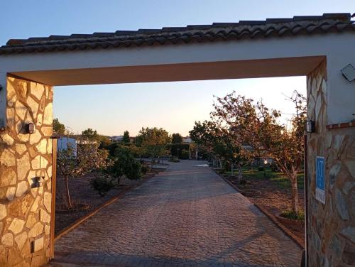 an entrance to a building with a brick road at Casa Rural El Valle in Torre de Miguel Sesmero