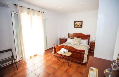 a bedroom with a bed and a table in it at Casa Rural El Valle in Torre de Miguel Sesmero