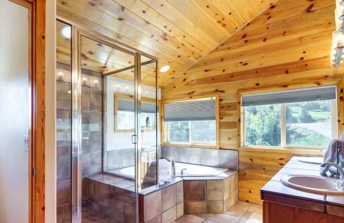 a bathroom with a shower and a sink at Duck Creek Cabin With Trailer Parking And Dog Enclosure in Alton