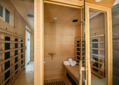 a sauna with wooden walls and wooden flooring at Blue Marlin All-Inclusive Seascape by Dream Resorts in Scottburgh
