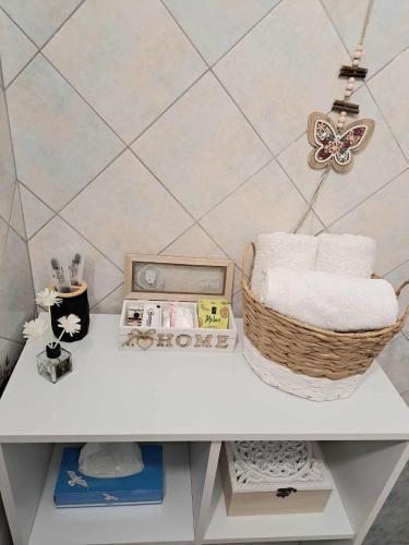 a white table with a basket of towels on it at Stelina's Guest House in Trikala in Tríkala