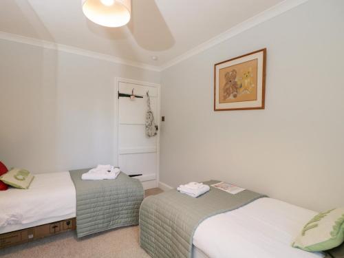 a bedroom with two beds and a picture on the wall at The Old Byre in Salisbury