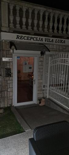 a door to a building with a sign on it at Guest house Vila Luka 2 in Portorož