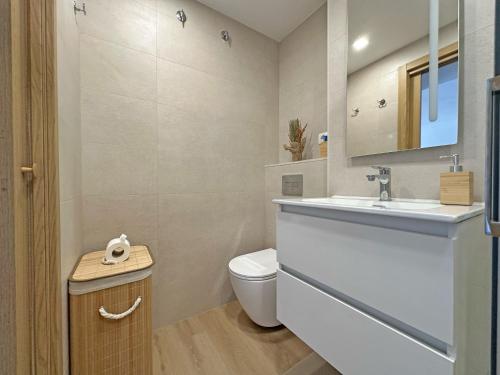 a bathroom with a white sink and a toilet at Sol y Mediterráneo in Oropesa del Mar