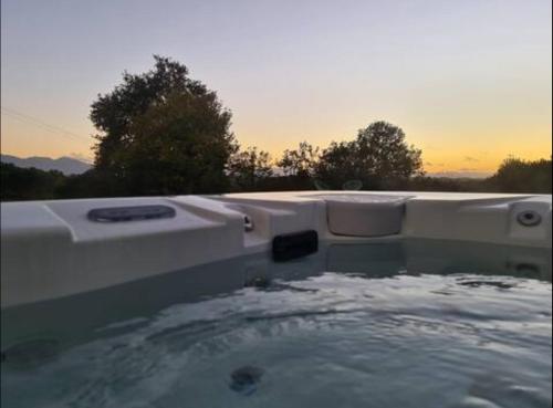 a bath tub with water in the middle of it at Chambre au cœur de la nature 