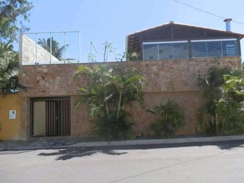a brick house with a window on top of it at Casa para temporada in Guarapari