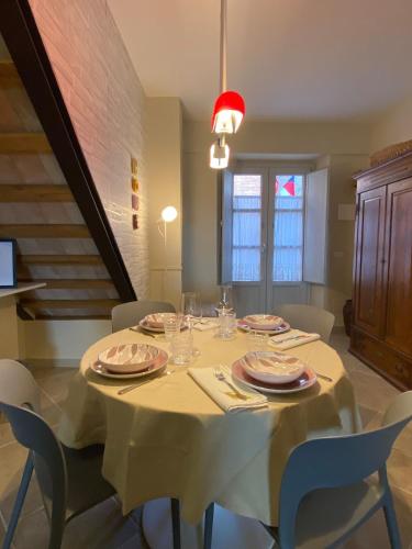 a dining room table with a white table cloth and chairs at Casa Danesi in Monteleone dʼOrvieto
