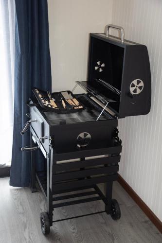 a bbq cart with a grill on top of it at Cabaña Vista ShangriLa, Las Trancas in Las Trancas