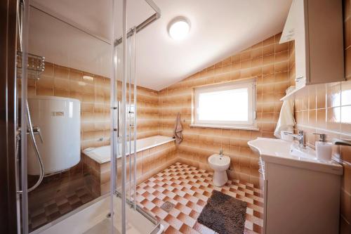 a bathroom with a shower and a toilet and a sink at Infinity Appartements in Vodice - Nord-Dalmatien in Vodice