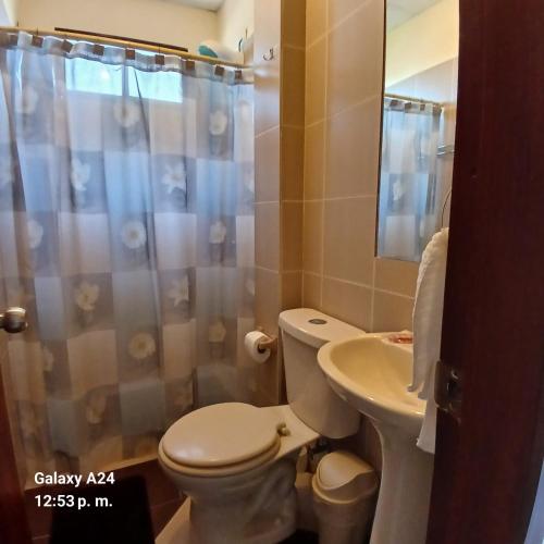 a bathroom with a toilet and a sink at Suites Sonikikos in Ballenita