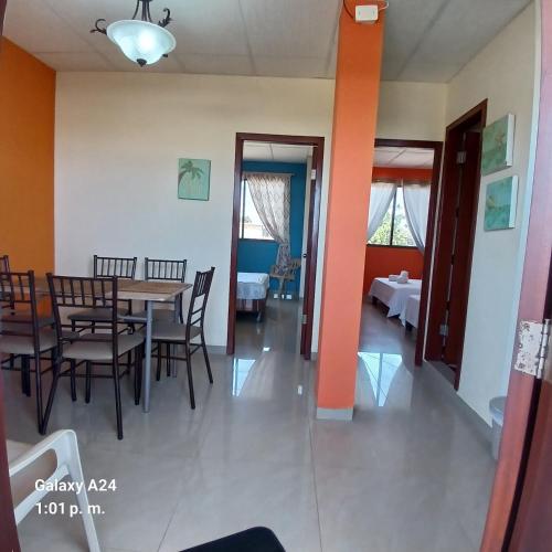 a dining room with a table and chairs at Suites Sonikikos in Ballenita