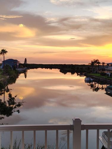 a view of a body of water at sunset at Waterfront and Gulfview Retreat Hernando Beach in Hernando Beach