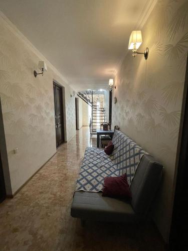a living room with a couch in a hallway at Happy Rustavi guest house in Rustavi