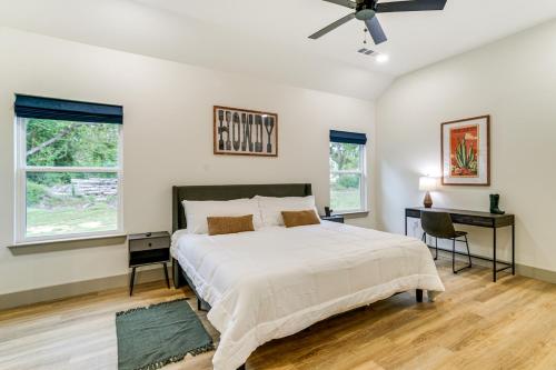 a bedroom with a bed and a desk and two windows at Lake-View Retreat with Games and Yard in Daingerfield in Lone Star