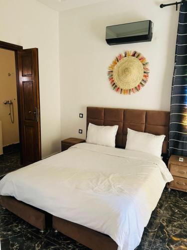 a bedroom with a bed with a wreath on the wall at Spacious and comfortable villa in Marrakesh