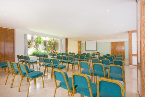 a room with a bunch of chairs and a screen at Iberostar Waves Creta Panorama & Mare in Panormos Rethymno