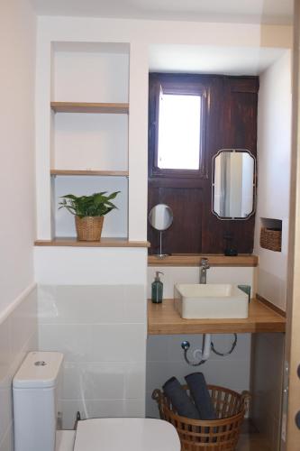 a bathroom with a white toilet and a sink at Casa Antonio-Tinajo in Tinajo