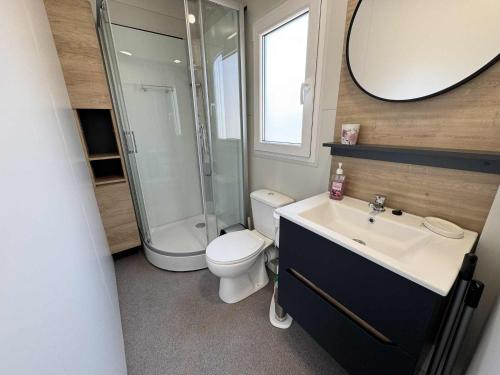a bathroom with a toilet and a shower and a sink at Ljubac Harmony Mobilház in Ljubač