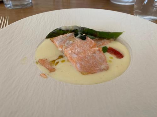 a white plate with a piece of food on it at Residence Apolonija Guest House in Sežana