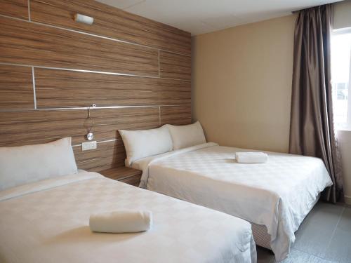 Ένα ή περισσότερα κρεβάτια σε δωμάτιο στο Mornington Hotel Medan Ipoh