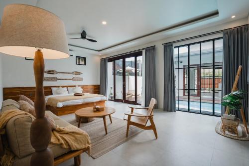a living room with a couch and a table at Honey Villa Canggu in Canggu