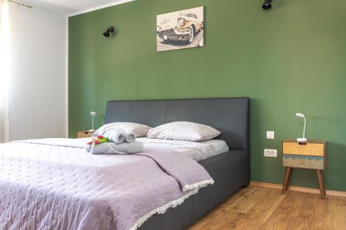 a bedroom with a bed with a stuffed animal on it at Guest house "The View" - with a pool in Donje Polje