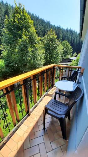 a balcony with a table and two chairs on it at Studio Wildwiese Rettenegg in Rettenegg