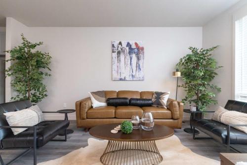 a living room with a couch and a table at Trinity River - Skyline Views - King bed in Fort Worth