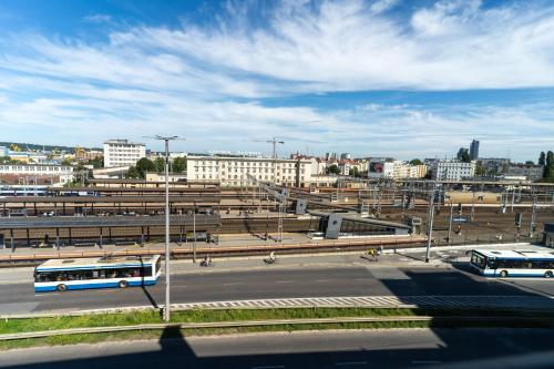 a city with buses parked in a parking lot at Apartamenty Przystanek Morska in Gdynia