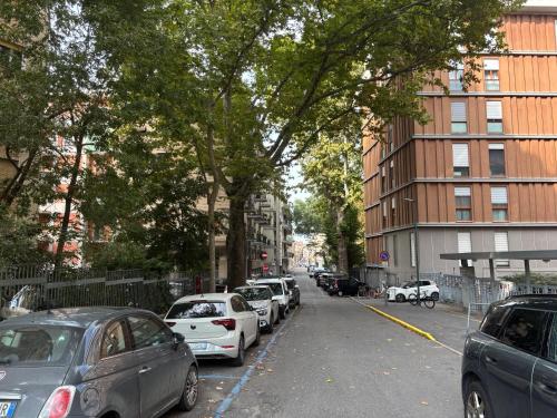 a street with cars parked on the side of the road at Salotto Santa Franca in Piacenza