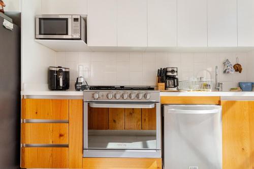 a kitchen with a stainless steel stove and a microwave at Casa Moderna en Cumbres del Lago Juriquilla in Juriquilla