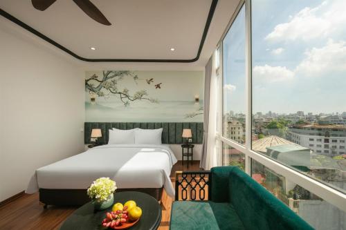 a hotel room with a bed and a large window at Hanoi Grandeur Hotel & Spa in Hanoi