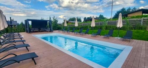 a swimming pool with lounge chairs and a screen at Mountain Hawk Park in Bansko