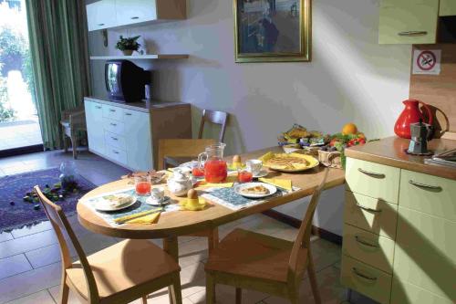 a kitchen with a table with food on it at Residence Spiaggia D'Oro in Desenzano del Garda