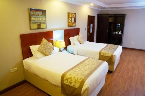 Ένα ή περισσότερα κρεβάτια σε δωμάτιο στο Jupiter International Hotel - Cazanchis