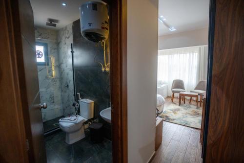 a bathroom with a toilet and a shower and a sink at Dar Atom pyramids in Cairo