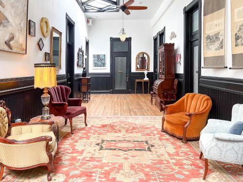 a living room with chairs and a rug at Swedetown European Style Hostel by Heirloom Boutique Collection in Duluth