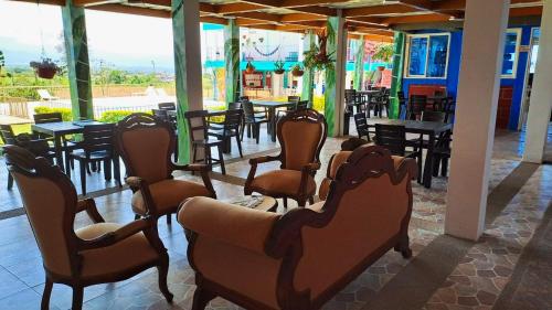 a group of chairs and tables in a restaurant at Hotel La Santamaria - Montenegro Quindío in Montenegro
